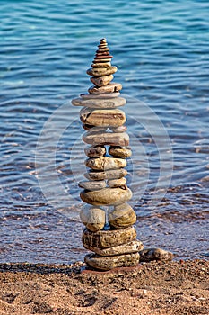 Made of stone tower on the beach. Balanced pebbles on beach