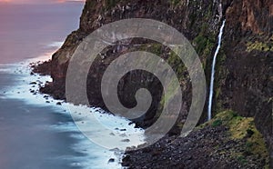 Madeira island - Dramatic sunrise over atlantic ocean with waterfall landscape from Miradouro do Veu da Noiva photo