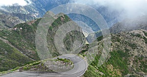 Madeira island, mountain road through the clouds with cliffs and beautifull nature surrounded on a sunny misty day in