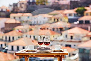 Madeira wine, coffee and bolo de mel with view to Funchal, Madeira, Portugal photo