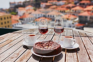 Madeira wine, coffee and hohey cake, View to Funchal, Portugal photo