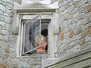 Madman looking out from asylum window