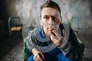 Madman, mouth sealed with plaster, violent patient