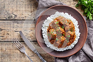 Madras butter Beef spicy Indian garam masala slow cook lamb food with rice and tomatoes