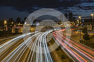 Madrid cityscape with road night lights trails. Contepts