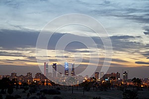 Madrid skyline at sunset, highlighting the four towers of the financial district to the north of the city