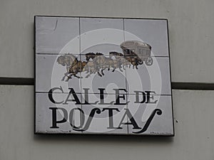 MADRID, SPAIN - DECEMBER 14, 2022: Street name calle de postas sign on in Madrid, capital of Spain renowned for its rich photo