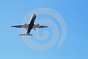 Airbus plane seen from below during the landing maneuver. photo