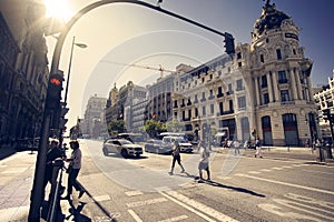 2019 09, Madrid, Spain. Madrid street, vintage style and sun flares. Pedestrian crossing and traffic lights on Alcala Street in