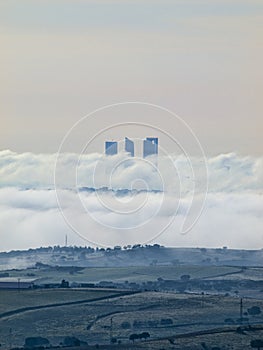 Madrid under clouds with Cuatro Torres Business Area view from Colmenar Viejo photo