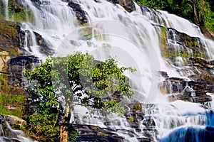 Mae Ya waterfall, beautiful cascade waterfall flowing in tropical rainforest, cataract at Doi Inthanon national park, Chiang Mai,