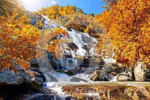 Mae Ya waterfall with green trees and blue sky backgroundat Doi Inthanon National Park,One of the famous waterfalls