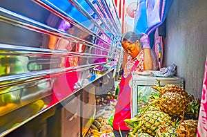 The train is riding through the Maeklong Railway Market, Thailand