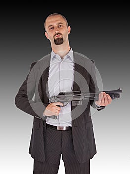 Mafia man is holding a shotgun