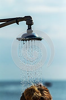 Mage of a vintage old shower head splashing water close up background. Water flows from the head of an old shower. Background for