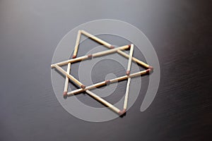 Magen David, Israel word from matches. Magen David, Israel from matches on a black wood. Concept of matches magen David, Israel