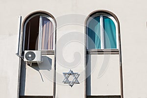 Magen David, the traditional jewish star, on display on the administrative building of the Belgrade synagogue, Serbia.