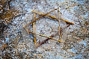 Magen David from tree branches on the ground in memory of the victims Jews during the Holocaust