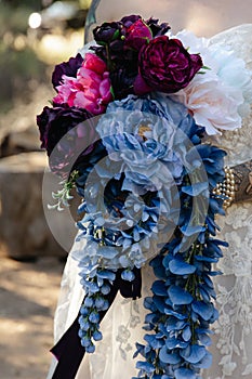 magenta, blue and pink peonis with wisteria - close up of bridal florals