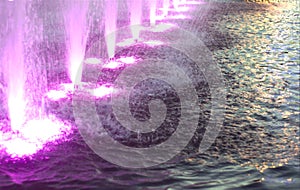 Magenta color lights and Water fountain jets