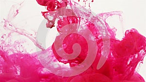 Magenta colored liquid slowly flowing