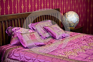 Magenta cushion on the bed