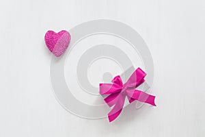Magenta heart and gift box on white painted old background. Valentine`s Day. Greeting card. Top view, flat lay