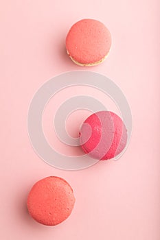 Magenta and pink macaroons on pink pastel background.  top view, close up