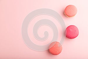 Magenta and pink macaroons on pink pastel background.  top view, copy space