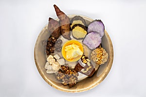 Maghe Sankranti Makar Festival Celebration Food Plate of Muri Ladoo, Sesame Ladoo, Yam, Sweet Potato, Jaggery, Peanuts Ladoo Ghe