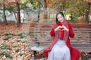 Magic autumn,Fall woman happy and bliss , Beautiful woman Sitting on a bench in autumn park