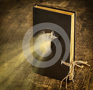 Magic Book closed on the rope emits light photo