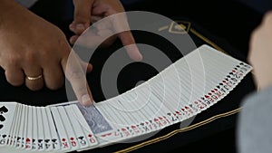 Magic, card tricks, gambling, casino, poker concept - man showing trick with playing cards