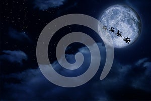 Magic Christmas eve. Santa with reindeers flying in sky