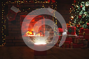 Magic Christmas present at the Christmas tree and fireplace