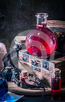 Magic concept. Red potion in bottle