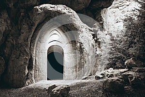 Magic dark portal in ancient stone arch fairytale background. Mysterious place surrounded with rock cliff showing way to