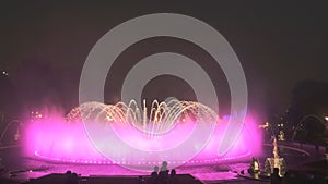 Magic fountain with pink lighting changing to orange in lima