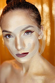 Magic Girl Portrait in Gold. Golden Makeup