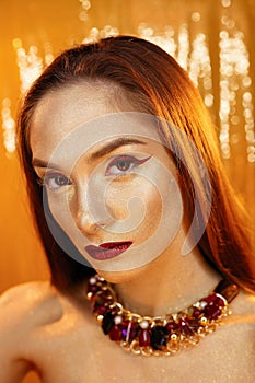 Magic Girl Portrait in Gold. Golden Makeup