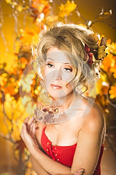 Magic gold autumn blonde girl portrait in leafs