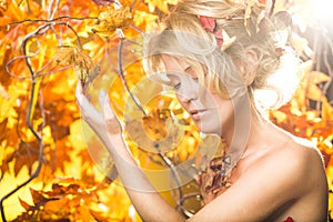 Magic gold autumn blonde girl portrait in leafs