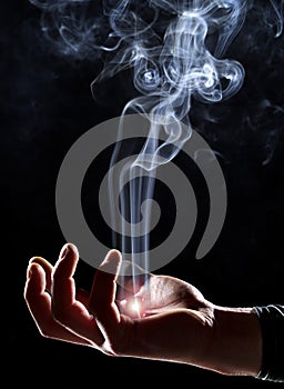 Magic hand with ascending smoke