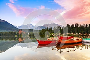Magic lake with red boats and canoe.