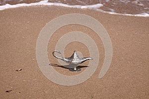 Magic lamp on a sand photo