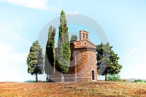 Magic landscape with chapel of Madonna di Vitaleta on a sunny day in San Quirico d`Orcia Val d`Orcia in Tuscany, Italy.