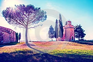 Magic landscape with chapel of Madonna di Vitaleta on a sunny day in San Quirico d`Orcia Val d`Orcia in Tuscany, Italy.