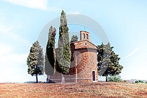 Magic landscape with chapel of Madonna di Vitaleta on a sunny day in San Quirico d`Orcia Val d`Orcia in Tuscany, Italy.