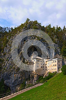 Magic landscape of medieval Predjama castle Slovene. Predjamski grad. Renaissance castle built within a cave mouth