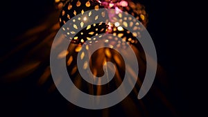 Magic lanterns spin and give beautiful glare to the walls. New Year glowing balls with led diodes are held in hands